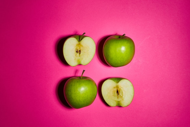 Fresh apples on pink background