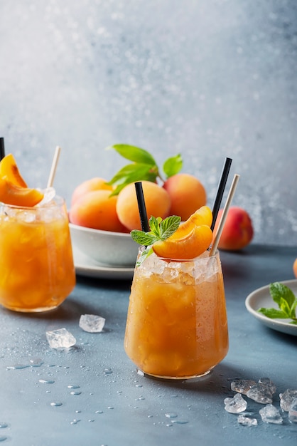 Fresh apricot cocktail with ice and mint