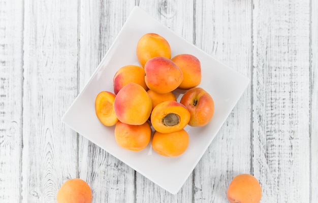 Fresh Apricots on wooden background selective focus