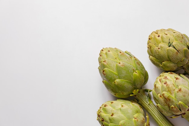 Fresh artichokes on rustic gray background