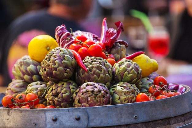 Fresh artichokes and tomatoes at farmers market