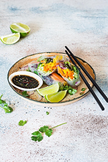 Fresh Asian appetizer Spring rolls Nem made from rice paper and raw vegetables and herbs