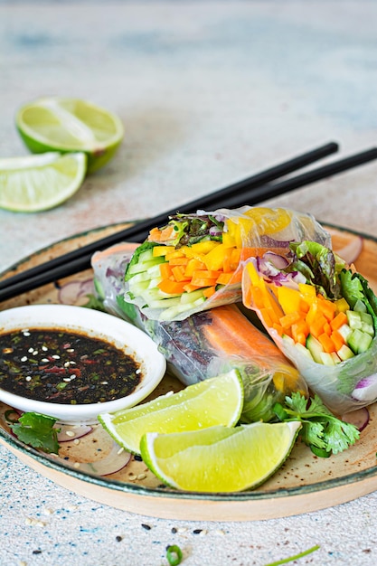 Fresh Asian appetizer Spring rolls Nem made from rice paper and raw vegetables and herbs