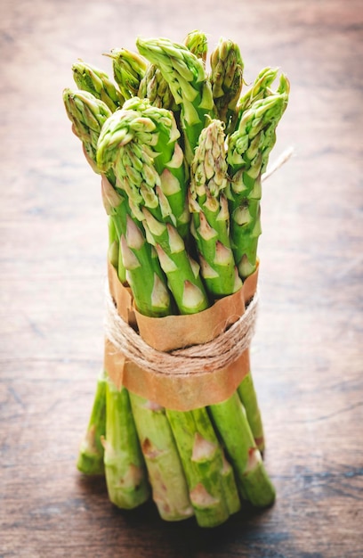 Fresh asparagus bunch on rustic wooden table background top view space for text