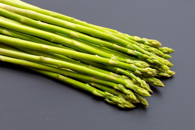 Fresh asparagus on dark background