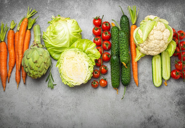 Fresh assorted organic vegetables arranged in line on rustic