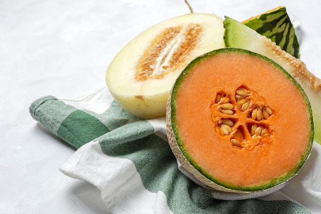 Fresh assortment melon with mint  on white