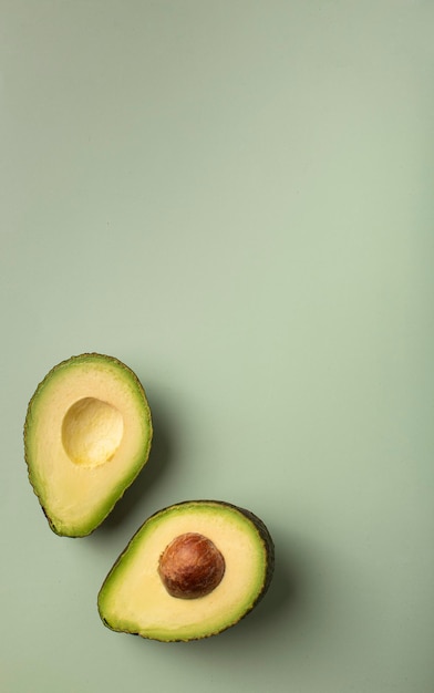 Fresh avocado pattern on a green background flat lay