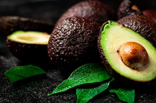 Fresh avocado with leaves On a black background