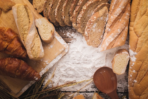 Fresh baked bread on dark wood table 