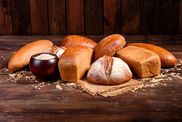 Fresh baked brown bread on a brown wooden