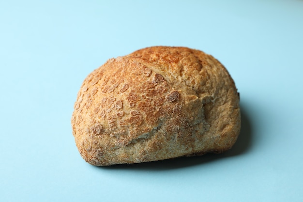 Fresh baked bun on blue