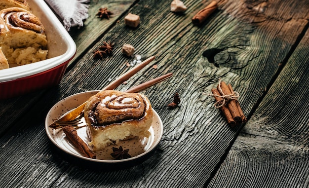 Fresh baked cinnamon rolls with vanilla icing, Cinnabon, banner, menu, recipe place for text, top view.