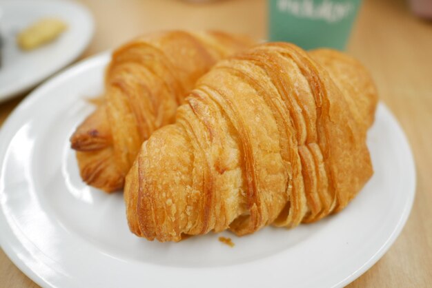 Fresh baked croissant on plate with copy space