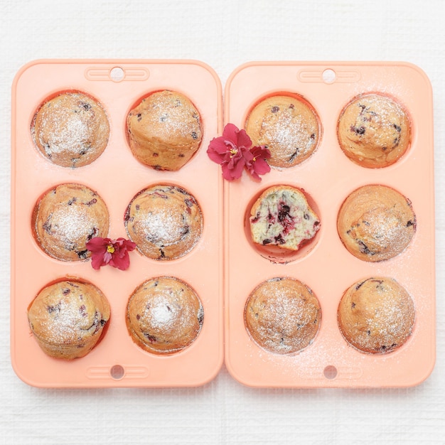 Fresh baked muffins or cupcakes in pink silicone baking tins, top view