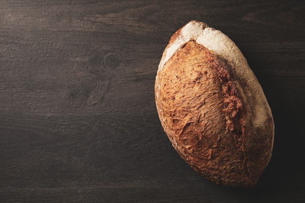 Fresh baked rye bread on black background