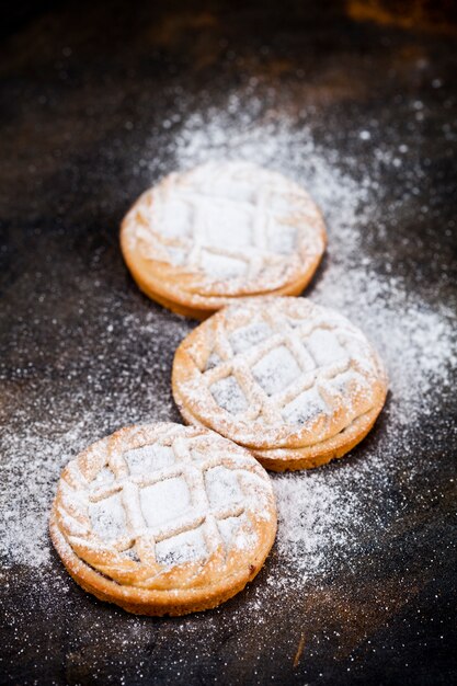 Fresh baked tarts with chocolate filling and sugar powder 