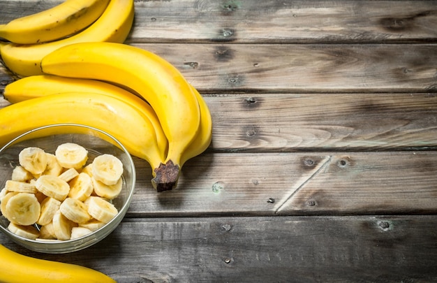 Fresh bananas and banana slices in a glass bowl