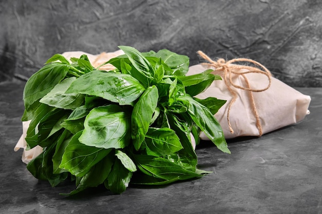 Fresh basil on a dark background green basil green basil on a dark background food background