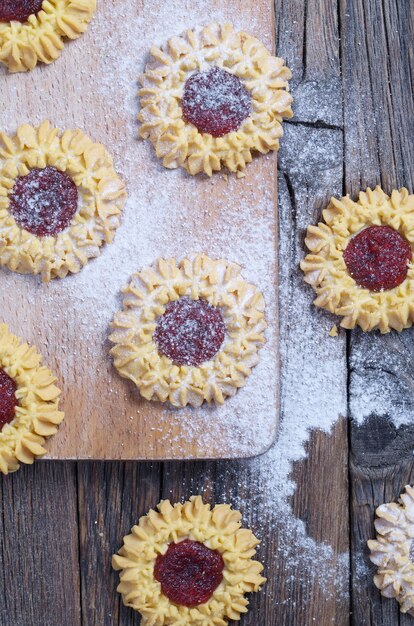 Fresh batch of cookies with filling on an old wood