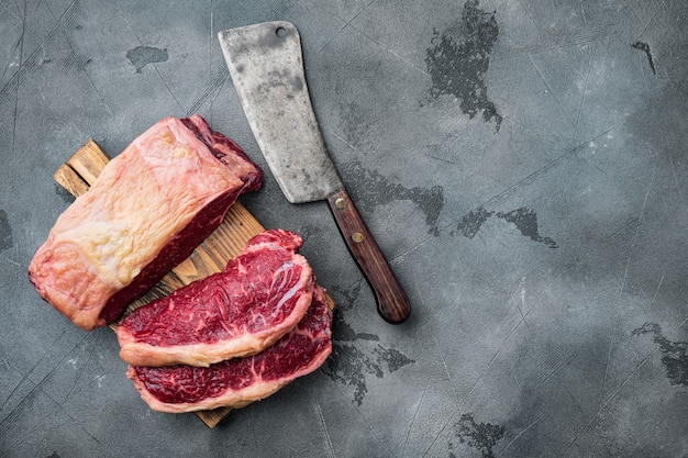 Fresh beef boneless club raw steak, on gray table, top view,