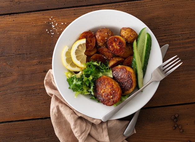 Fresh beef cutlets with new potatoes and salad