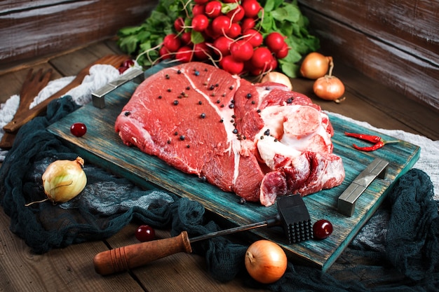 Fresh beef veal meat on rustic wooden table