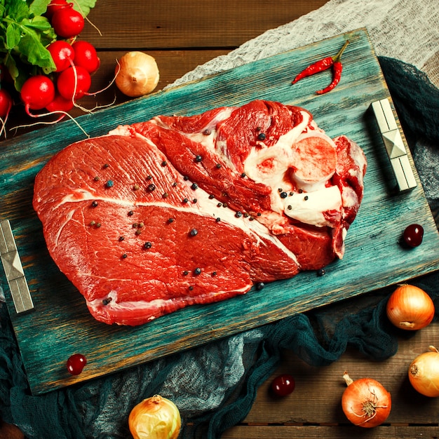 Fresh beef veal meat on rustic wooden table 