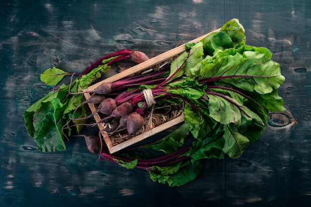 Fresh beets in Wooden Box On a wooden background Top view Copy space