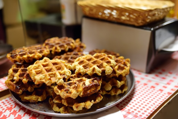 Fresh belgian waffles on Christmas market in Tallinn. Street food on Xmas fair.