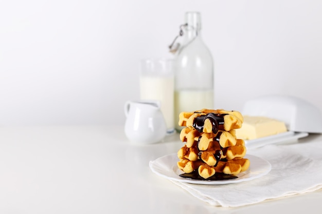 Fresh Belgian waffles with chocolate white wooden background selective focus with copy space