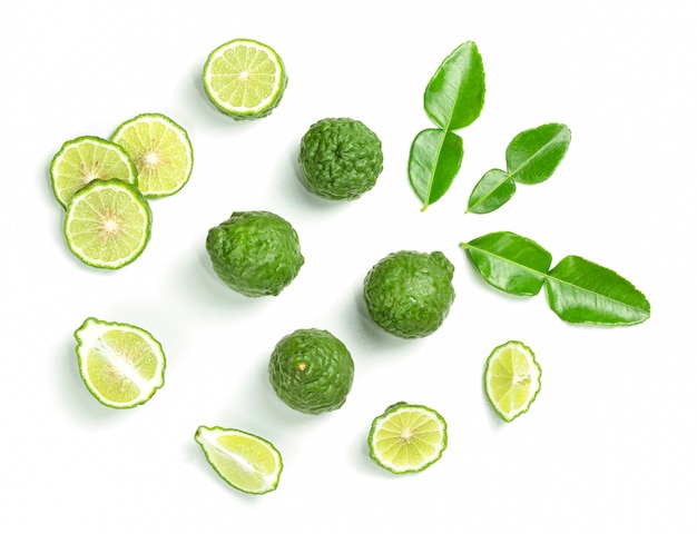 Fresh Bergamot fruits cut in half with leaves isolated on white