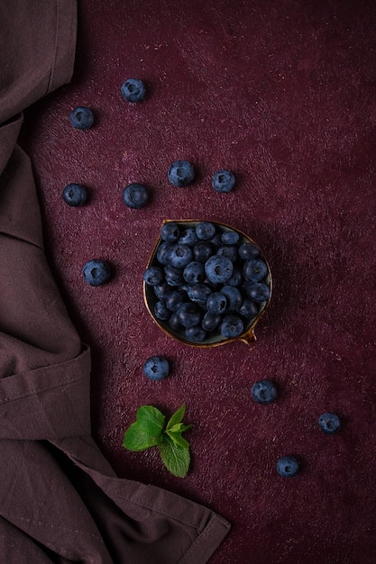 Fresh berries Blueberries on a maroon background food concept vertical no people