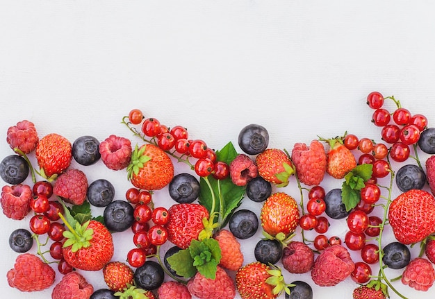 Fresh berries. strawberries, raspberries and blueberries on a white background, summer harvest, berries and superfood