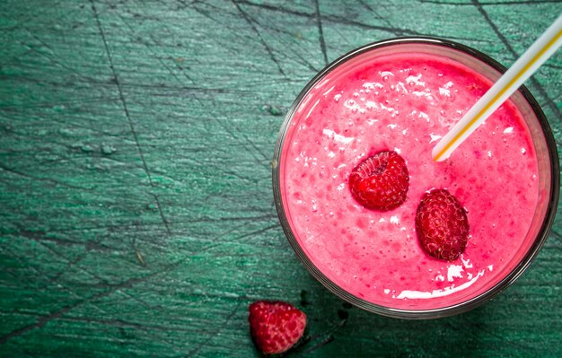 Fresh berry smoothie on rustic background