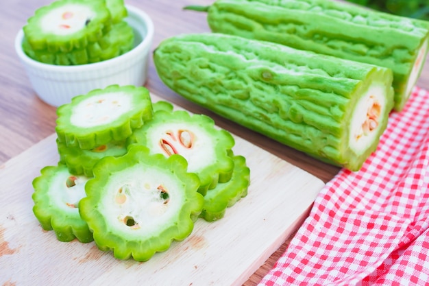 Fresh bitter gourd on wooden table