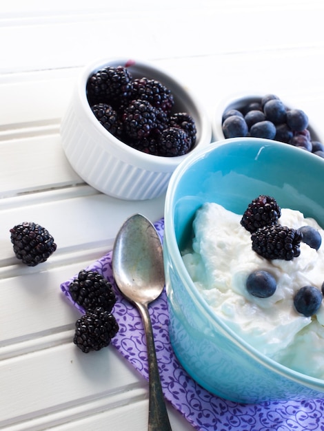 Photo fresh blackberries and blueberries with non-fat greek yogurt.