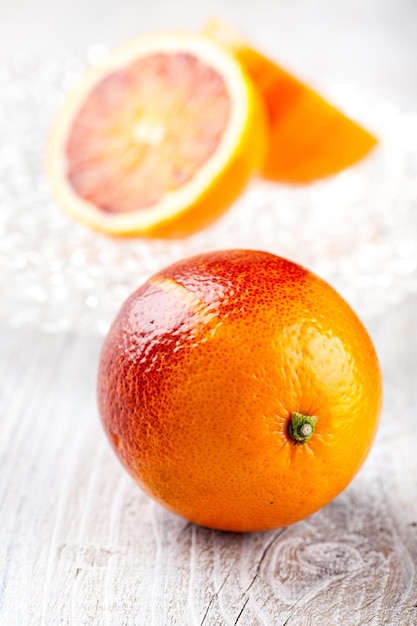 Fresh blood oranges on glass plates