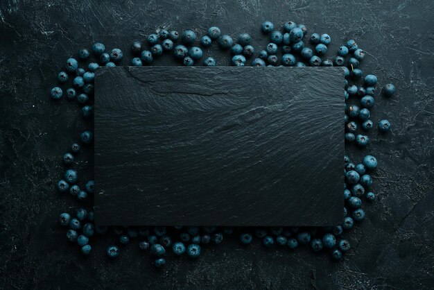 Fresh blueberries on a black stone background Free copy space