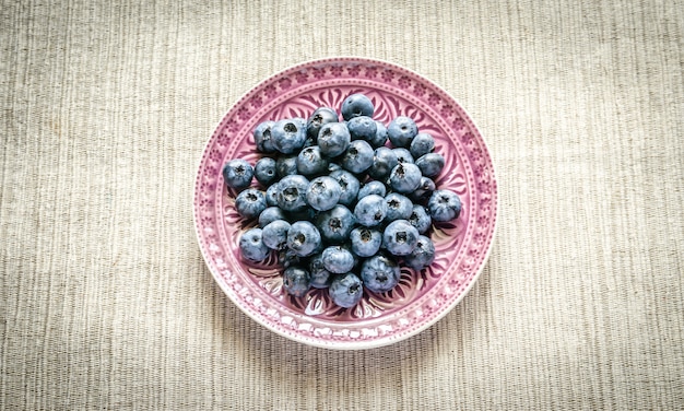 Fresh blueberries on the decorated plate