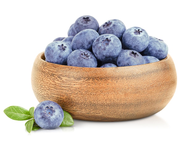 Fresh blueberries in a wooden plate on a white isolated background