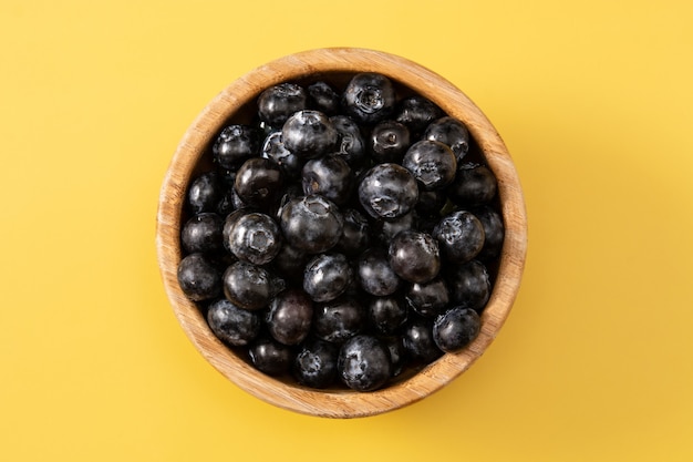 Fresh blueberries on yellow surface