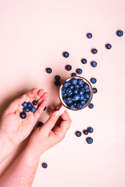 Fresh blueberry fruits in a cup top view.