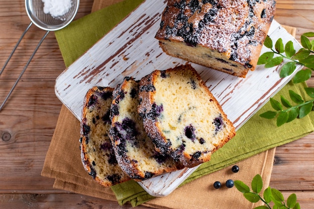 Fresh blueberry loaf of bread muffin cake on wooden table Horizontal top view from above