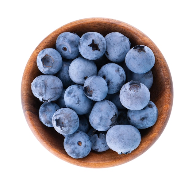 Fresh blueberry in wooden bowl isolated on white background Bilberry or whortleberry Clipping path Top view