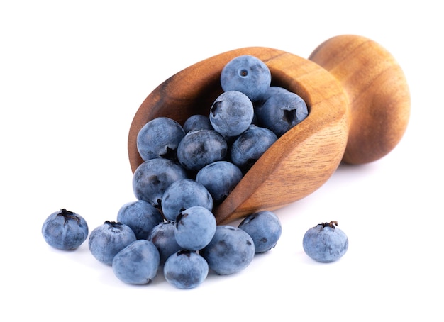 Fresh blueberry in wooden scoop isolated on white background Bilberry or whortleberry