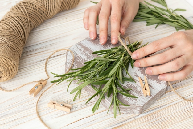 Fresh branches of rosemary on a white wooden table