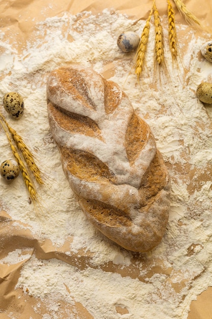 Fresh bread in flour on food paper