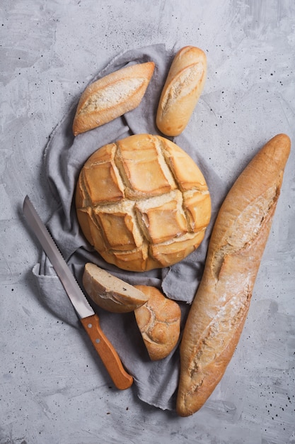 Fresh bread on a gray concrete background. Top view with copy space