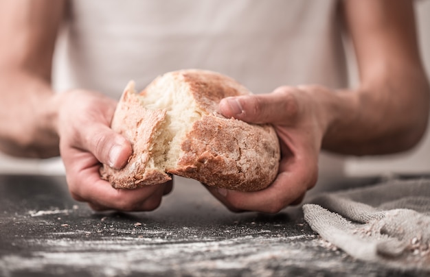 fresh bread in hands closeup on